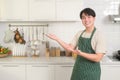 portrait of smart young Asian man smiling in kitchen at home Royalty Free Stock Photo