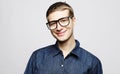 Portrait of a smart young man wearing eyeglasses standing against white background Royalty Free Stock Photo