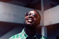 Portrait of smile bearded African man wearing sunglasses.Low key style Royalty Free Stock Photo