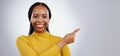 Portrait, smile and black woman with hand pointing in studio for presentation, checklist or promo on grey background