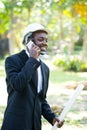 Portrait of smile business african man talking smartphone with the nature background Royalty Free Stock Photo