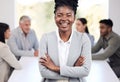 Portrait, smile and a business black woman arms crossed in the boardroom with her team in the background. Leadership Royalty Free Stock Photo