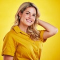 Portrait, smile and carefree with a woman on a yellow background in studio feeling positive. Face, happy and kindness Royalty Free Stock Photo