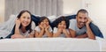 Portrait, smile and children with parents in bed relaxing and bonding together at family home. Happy, fun and young Royalty Free Stock Photo