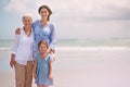 Portrait, smile and family generations on beach in summer together for travel, holiday or vacation. Senior mother, woman Royalty Free Stock Photo