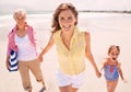 Portrait, smile and family holding hands on beach for walking in summer on travel, vacation or holiday. Grandma, mother