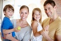 Portrait, smile and family in home for love, bonding and siblings together with fruit. Face, happy parents and kids in Royalty Free Stock Photo