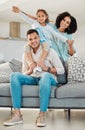 Portrait, smile and family on sofa in home living room, bonding and relax together. Interracial, happy and father