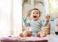 Portrait, smile and happy baby with toys on floor for fun, playing and game at home. Face, excited and toddler boy with Royalty Free Stock Photo