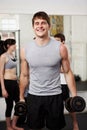 Portrait, smile and man with fitness, weights and training with progress, challenge and funny. Person, athlete and guy