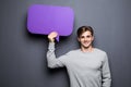 Portrait of smile Man holding purple blank speech bubble with space for text Royalty Free Stock Photo