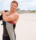 Portrait, smile and man in wetsuit at beach for sports surfing, fitness or exercise on summer vacation. Travel, health Royalty Free Stock Photo