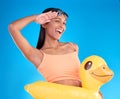 Portrait, smile and salute with a swimmer woman in studio on. a blue background wearing goggles on her head. Happy, hand