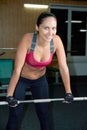 Portrait, smile and woman at barbell in gym for exercise, training and power of strong bodybuilding. Happy female Royalty Free Stock Photo