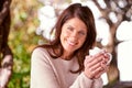 Portrait, smile and woman drinking coffee, cappuccino or espresso in backyard garden of home. Bokeh, morning and face of Royalty Free Stock Photo