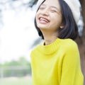 Portrait smile young girl wear yellow sweater on nature background Royalty Free Stock Photo