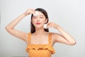 Portrait of smile young woman holding white cotton pad in her hand for removing make-up on  on white background Royalty Free Stock Photo