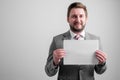 Portrait of smileing business man wearing business clothes holding white paper Royalty Free Stock Photo