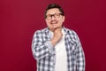 Portrait of smiley pondering handsome middle aged business man in casual checkered shirt and eyeglasses standing looking away and Royalty Free Stock Photo