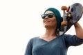 Portrait of a smiling adult female skateboarder holding a skateboard. Woman with skating board at skate park looking at Royalty Free Stock Photo