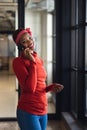 Portrait of smiling african american businesswoman talking on smart phone in creative office Royalty Free Stock Photo