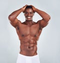 Portrait of a smiling African American fitness model posing topless in a underwear and looking muscular. Happy black Royalty Free Stock Photo