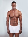 Portrait of a smiling African American fitness model posing topless in a underwear and looking muscular. Happy black Royalty Free Stock Photo