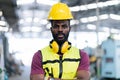 Portrait of smiling African American industrial worker man with helmet crossed arms in industry factory .happy confidence black Royalty Free Stock Photo