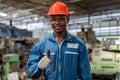 Portrait of smiling African American industrial worker man with helmet show thumbs up in factory .happy confidence black male Royalty Free Stock Photo