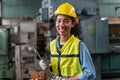 Portrait of smiling African American industrial worker woman with helmet crossed arms holding wrench industry factory .happy Royalty Free Stock Photo