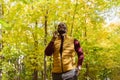 Portrait of smiling african american man talking on mobile phone outside in autumn park - business communication and Royalty Free Stock Photo