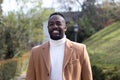 Portrait of a smiling African american man well dressed. Posing. In a park Royalty Free Stock Photo