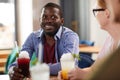 African-American Man Enjoying Drinks with Friends Royalty Free Stock Photo