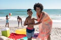 Portrait of smiling african american mother and son standing with father and daughter at beach Royalty Free Stock Photo