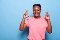 Portrait of smiling african american teenager keeping fingers crossed