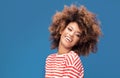 Smiling afro woman in sailor style shirt.