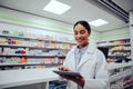Portrait of smiling african doctor woman working in drugstore with digital tablet Royalty Free Stock Photo