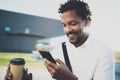 Portrait of Smiling American African man in headphone at sunny city with coffee in take away cup and enjoying to listen Royalty Free Stock Photo