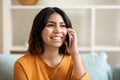 Portrait Of Smiling Arab Female Talking On Mobile Phone At Home