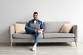 Portrait of smiling Arab man using laptop at home