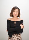 Portrait of a smiling asian businesswoman standing with arms folded and looking at camera isolated over white background Royalty Free Stock Photo