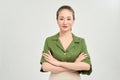 Portrait of a smiling asian businesswoman standing with arms folded and looking at camera isolated over white background Royalty Free Stock Photo