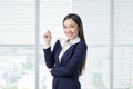 Portrait of smiling asian businesswoman standing in bright office Royalty Free Stock Photo