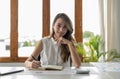 Portrait of smiling asian businesswoman working on desktop. Royalty Free Stock Photo