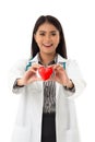 Portrait of smiling asian female cardiologist with stethoscope holding red heart shape model Royalty Free Stock Photo