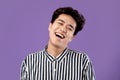 Portrait of smiling Asian guy posing laughing at studio Royalty Free Stock Photo