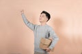 Portrait smiling Asian man holding post boxes standing over isolated background with copy space Royalty Free Stock Photo