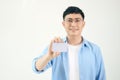 Portrait of smiling Asian man holding white blank business card on white background Royalty Free Stock Photo