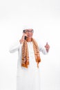 Portrait of smiling asian muslim old man talking on a smartphone and raise one arm isolated over white Royalty Free Stock Photo