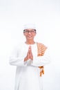 Portrait of smiling asian muslim old man wear white clothes welcoming you isolated over whit Royalty Free Stock Photo